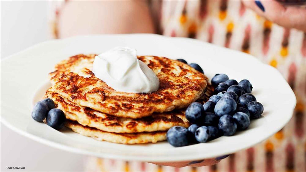 A plate of keto pancakes with whipped cream and peanut butter